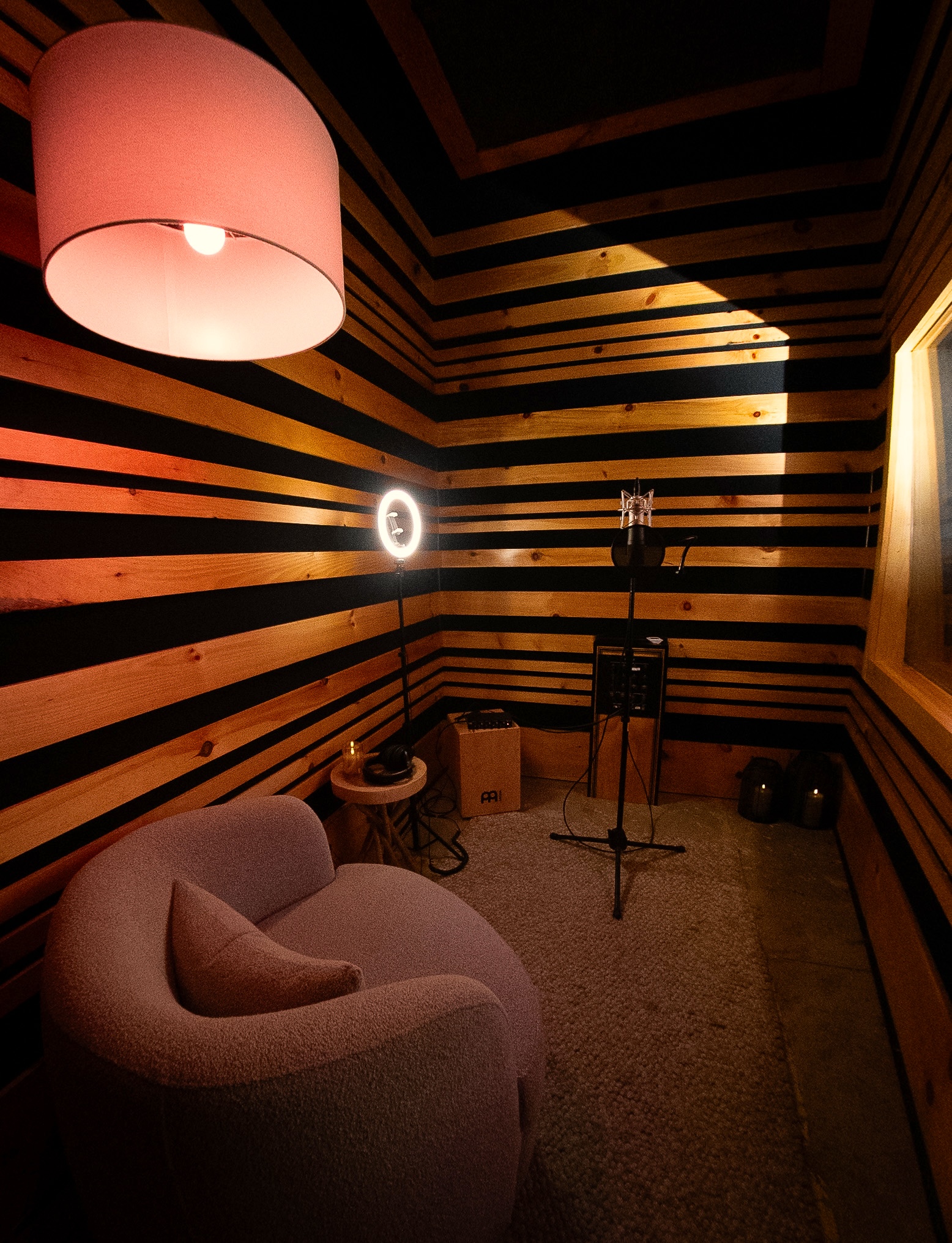 Intimate recording booth with wood-stripe acoustic panels