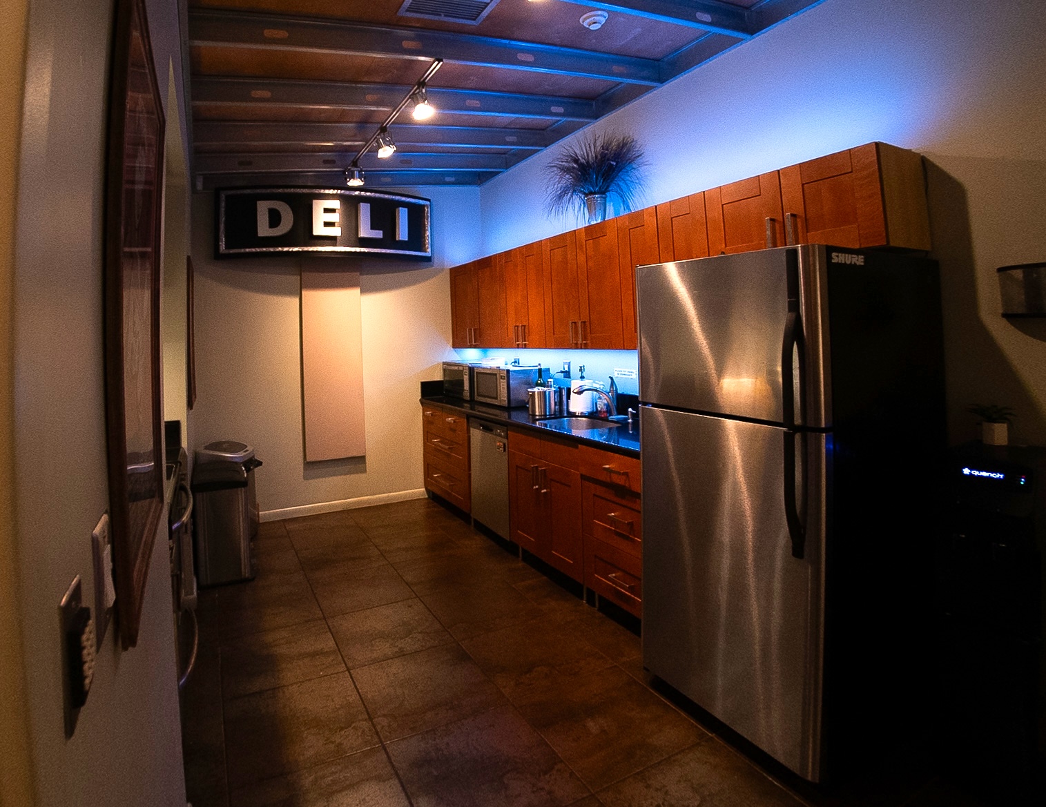 Studio kitchen and lounge area with Deli sign